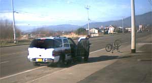 Tillamook Cop Arrests and carts off bicyclist (click for larger version)